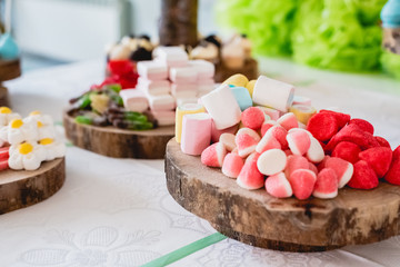 Desserts and wedding cake with very sweet cupcakes at an event.