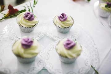 Desserts and wedding cake with very sweet cupcakes at an event.