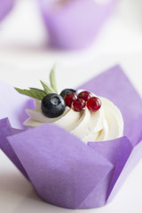 Colorful cupcakes with buttercream and fresh berries