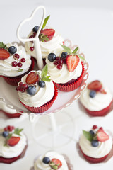 Colorful cupcakes with buttercream and fresh berries