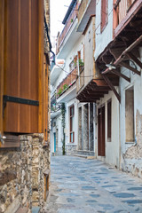 Narrow alleys with traditional greek houses at Skopelos old town, sunset at Skopelos island, Greece