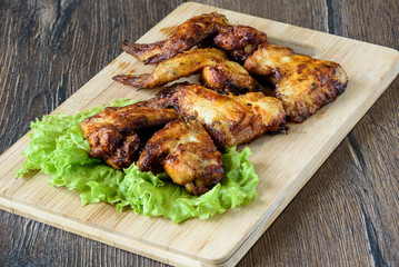 Hot and spicy buffalo chicken wings on cutting board
