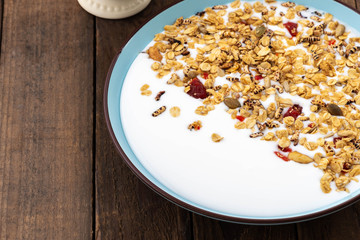 Granola, oatmeal with milk, honey and strawberry on blue plate
\
