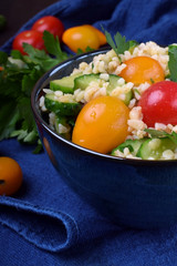 Tabbouleh salad with bulgur, cucumbers and tomatoes. Middle Eastern cuisine meal