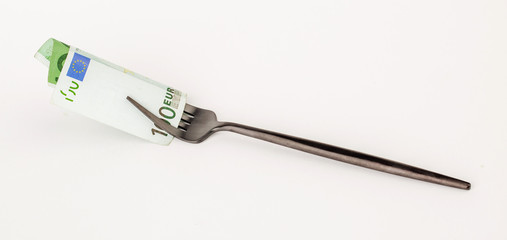 Fork with money on white background