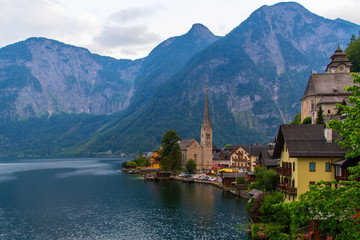 Fototapeta na wymiar View of the Alpine town of Hallstatt on the shore of a mountain lake at sunset