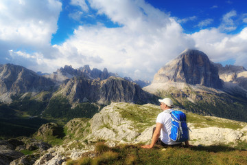 Naklejka premium Man admires the mountain landscape of the Alpine peaks.