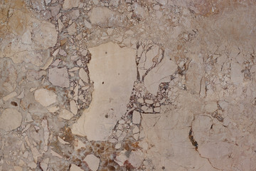 Brown structure with fractures and spots. Natural material. Classic travertine texture.