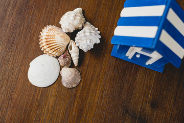 Wooden toy house with beach and maritime motifs.