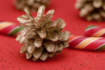 Golden Christmas cone and long Lollipop on red background
