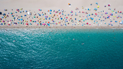 Aerial view of crowded sandy beach line © jujopeto
