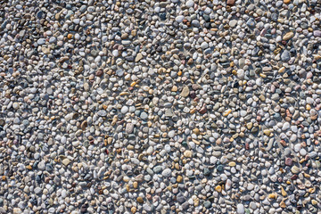 Concrete wall with pebbles.