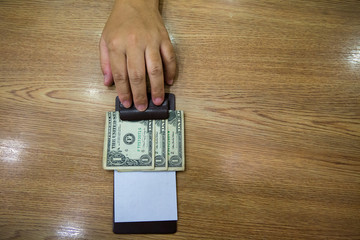 Customer handed the cash on bill paper. US dollar banknote tips in leather black bill reciept. USA...