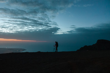 A photographer taking photos near Famara, Lanzarote, Spain