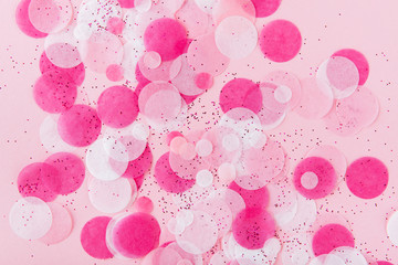 Flatlay of Colorful Round Paper Confetti on pink Paper