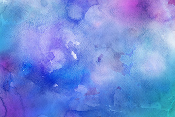 Colorful watercolor ombre leaks and splashes texture on white watercolor paper background. Natural organic shapes and design.