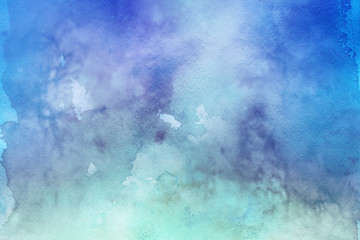 Colorful watercolor ombre leaks and splashes texture on white watercolor paper background. Natural organic shapes and design.