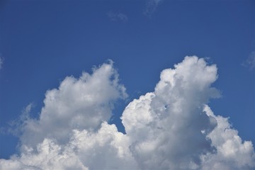 Amazing cumulus clouds and sunlight on the background of clear blue sky, Summer in GA USA.