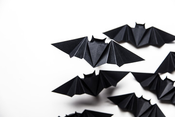 Halloween origami paper dracula bats on a white background