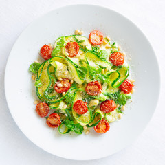 parboiled zucchini noodles with  fried cherry tomatoes, garlic oil, basil, pine nuts, and grated cheese