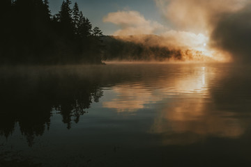 Sunrise on foggy lake