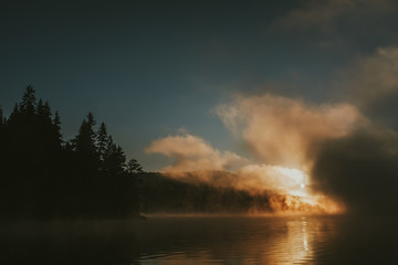 Naklejka na ściany i meble Sunrise on foggy lake