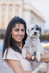 Beautiful Smiling Woman Hugging  Her Cute Havanese Dog .Pet and Owner Outdoor