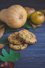 Autumn background. Cookies, Pumpkin Leaves Plaid Apples on a wooden background