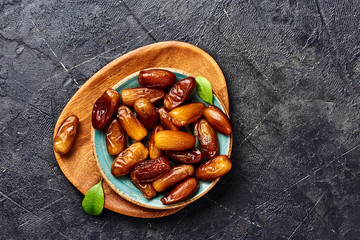 Dried dates fruits on plate with copy space. Top view of pitted dates.
