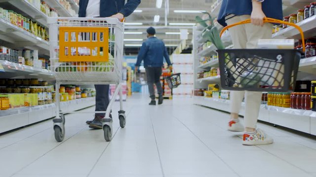 Low Angle Footage At the Supermarket: Canned Goods Section, Customers Browsing Through Shelves and Buying Products.