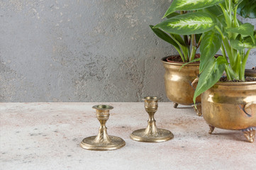 Vintage candlesticks on concrete background.