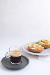 Fresh green figs sandwiches canapes Grey rustic plate Black coffee Espresso Wholegrain bread Goat cheese Healthy eating concept Appetizer Isolated Copy space White background