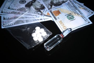 drug trafficking, crime, addiction and sale concept - closeup of with drugs and money.