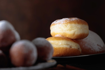 Sweet donuts with cinnamon sticks powdered with sugar.