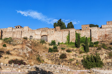 External view of Alcazaba Walls - palatial fortress in Malaga built in XI century. Fortress palace, whose name in Arabic means citadel, is one of city's historical monuments. Malaga, Andalusia, Spain.
