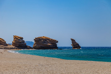 The beach of Triopetra with rocks and turquoise sea in Southern Crete, Greece. Beautiful background Mediterranean sea.