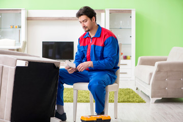 Repair contractor repairing broken furniture at home