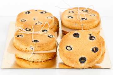 Round shortbread biscuits with black olives. fresh homemade cookies
