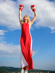 Lady fighter enjoy celebrate victory. Satisfied free girl boxing gloves. Winner concept. Femininity and strength balance. Woman red dress and boxing gloves enjoy victory. She fighter female rights