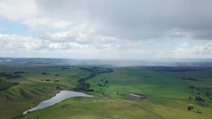 Aerial drone shot of the fields with the city on the bacground
