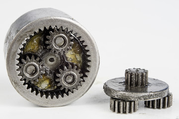 Planetary gear from a small device on a bright table. Gear wheels from a specialist device.
