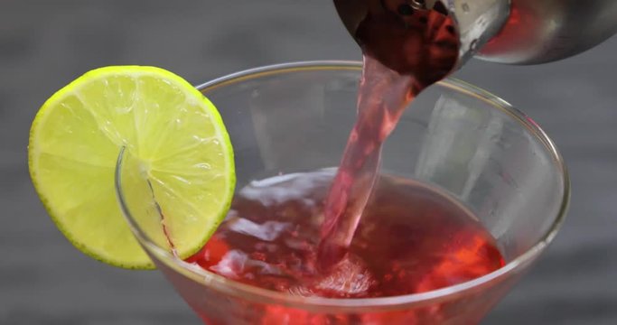 Close up of pouring classic cocktail,  Cosmopolitan