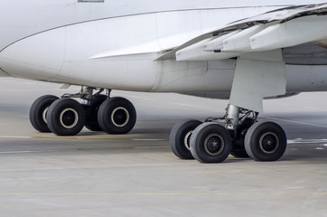 Landing gear of big passenger aircraft close up high detailed view.