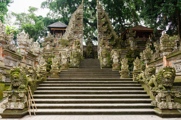 Fototapeta na wymiar Entrance with statues in Pura Gunung Lebah, Ubud, Bali, Indonesia