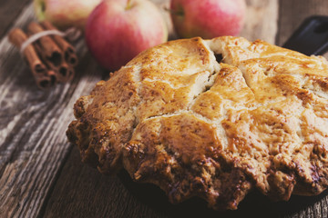 Apple pie in cast iron skillet on rustic wooden table