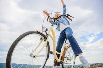 Freedom and delight. Most satisfying form of self transportation. Cycling gives you feeling of freedom and independence. Girl rides bicycle sky background. Woman feels free while enjoy cycling
