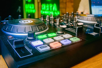 Fototapeta na wymiar DJ booth. Mixer for CDs and create a control music closeup with buttons and controllers.