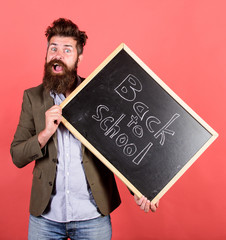 Take it easy. Teacher bearded man holds blackboard with inscription back to school red background. Teacher with tousled hair stressful about school year beginning. Teaching stressful occupation