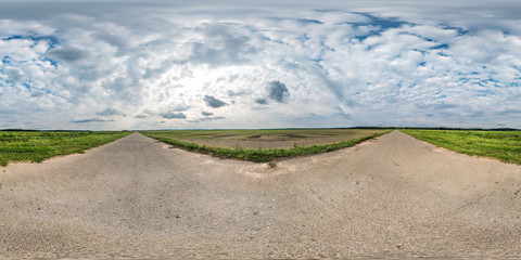 full seamless spherical panorama 360 by 180 degrees angle view on gravel road among fields with...