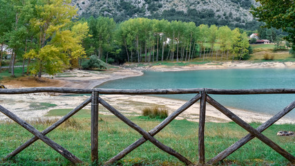 Fototapeta na wymiar wooden fence on the coast of the lake